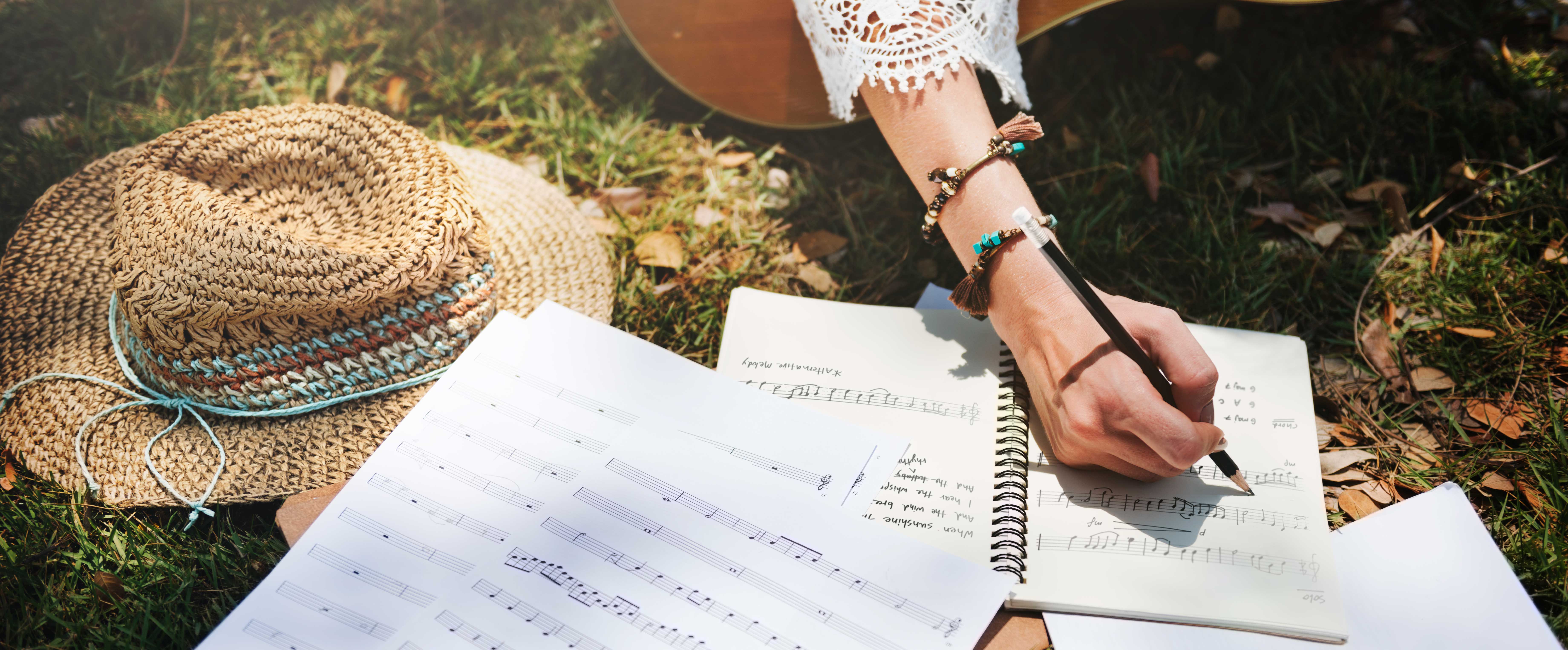 woman writing down some lyrics